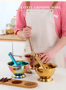 Detailed view of colorful stainless steel mortar and pestle sets in a kitchen setting