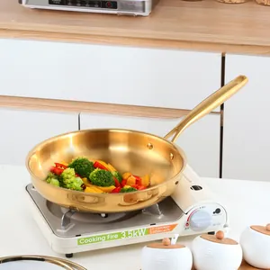 Golden 304 stainless steel frying pan with ergonomic handle and fresh vegetables