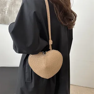 Chic heart-shaped crossbody bag in beige embossed faux leather with dual zippers