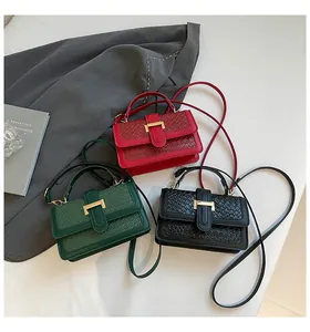 Detailed trio of woven texture crossbody bags in red, green, and black with gold hardware