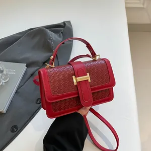 Chic red woven texture handbag with golden H-clasp and adjustable shoulder strap