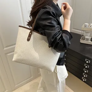 White woven leather tote bag with large capacity and brown straps for minimalist commuting