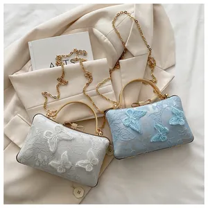 Detailed embroidery of 3D lace butterflies on elegant blue and beige crossbody bags