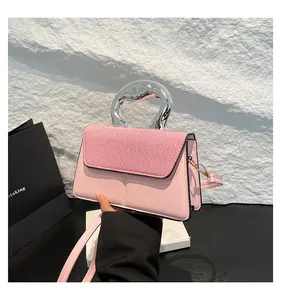 Pink contrast mini bag with silver textured metal handle and woven flap detail