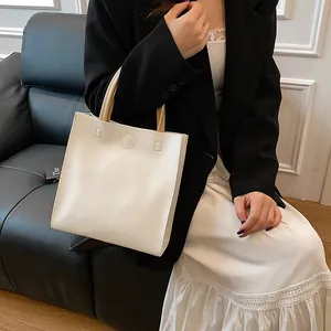 Minimalist cream white leather tote bag with circular handles for vintage luxury fashion