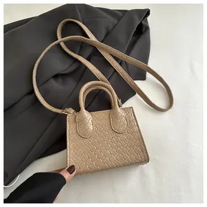 Macro shot of khaki mini tote bag showing intricate woven texture and smooth handle details