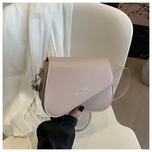 Detailed close-up of a minimalist beige square crossbody bag with Fashion Trend logo
