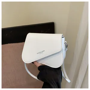 Detail of white saddle bag with asymmetric flap and Fashion Trend 1996 text