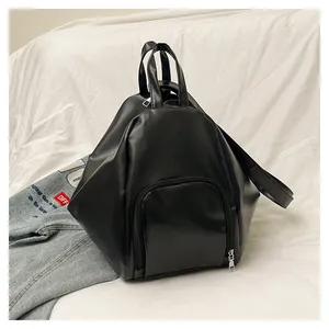 Detail view of black geometric backpack with smooth PU leather texture and silver zipper