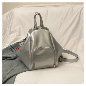 Detail of silver geometric backpack with metallic finish and adjustable shoulder straps