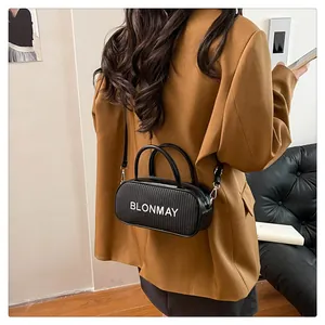 Detail view of woven texture and BLONMAY logo on black baguette shoulder bag for women