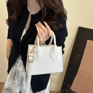 Chic white crocodile embossed mini handbag with gold hardware and dual handles for women