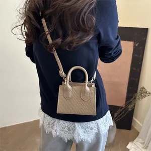 Khaki woven texture small square tote bag with adjustable shoulder strap and top handle