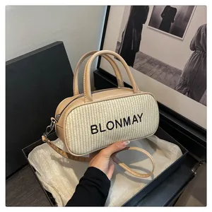 Detail of BLONMAY beige baguette bag showing woven texture and adjustable shoulder strap