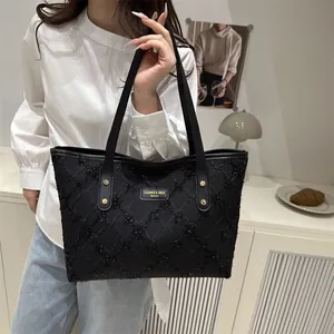 Chic black tweed tote bag with silver logo and leather handles for stylish daily use
