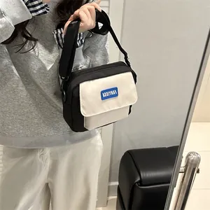 Petit sac bandoulière bicolore noir et blanc avec sangle réglable et logo central
