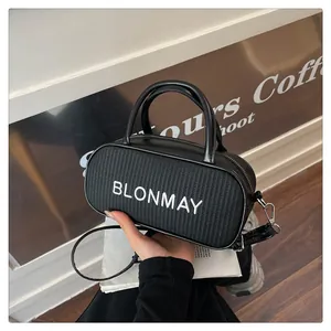 Detail of BLONMAY woven mini baguette bag with white logo and sleek silver hardware