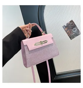 Detailed view of a pink glitter handbag with gold lock and detachable shoulder strap