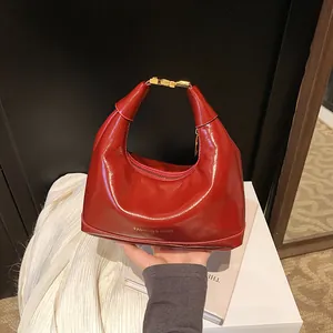 Glossy red hobo handbag with gold hardware and fashion embossing for women's spring style