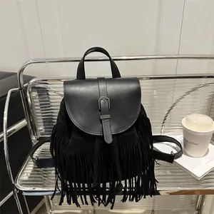 Modern black tassel backpack with sleek leather flap and polished gunmetal buckle detail