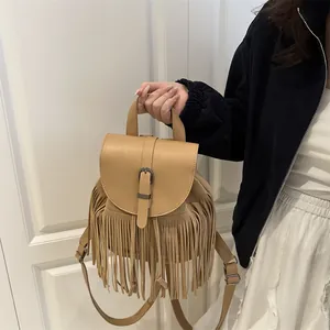 Bohemian light brown leather backpack with long tassels and vintage metal buckle closure