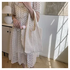 Gros plan du sac fourre-tout en crochet crème montrant la texture du tissage