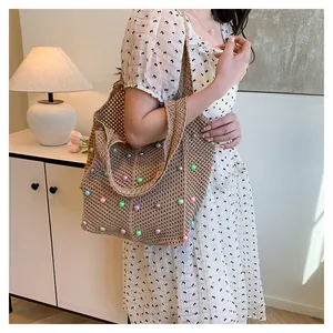 Close-up of woven tote bag featuring colorful faux pearls and handmade crochet details