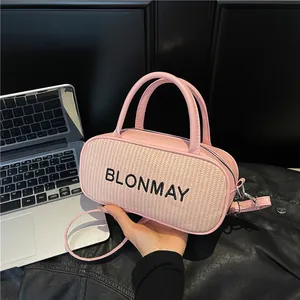Modern pink baguette bag with woven texture and top handles for versatile crossbody wear