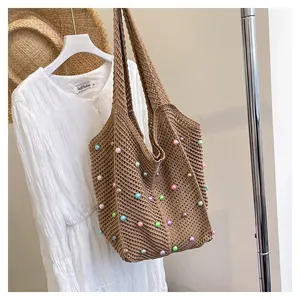 Detailed close-up of brown woven crochet tote bag featuring colorful bead accents