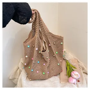 Detail of hand-woven hobo bag with colorful pearl beads and soft mesh texture