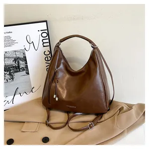 Detail view of the brown vintage PU leather hobo bag with fringe and metal hardware