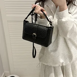 Classic black woven texture handbag with gold buckle and adjustable shoulder strap