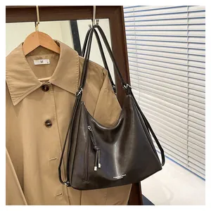 Deep brown matte leather hobo bag with fringe zipper detail and dual straps