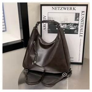 Macro shot of dark brown PU leather backpack with side fringe zipper and fashion lettering