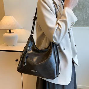 Chic black glossy hobo bag with Fashion & Bags text on minimalist modern background
