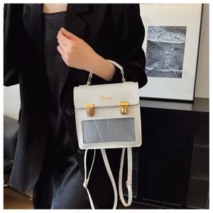 Detail of white convertible backpack with gold buckles and Mudnay brand logo