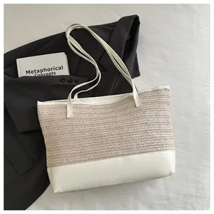 Detail of contrast stitch straw tote bag with cream woven texture and white smooth base