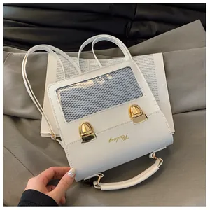 Macro view of white leather backpack with transparent display window and gold buckles