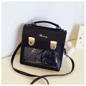 Detail of black PU leather crossbody bag with transparent PVC window and gold metal latches