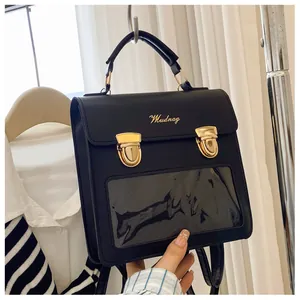 Close-up of black leather bag with gold buckles and clear PVC display window for pins