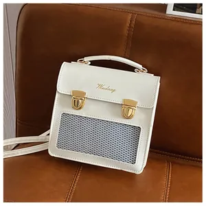 Detail of white Wudnag shoulder bag with gold metal buckles and grey mesh pocket