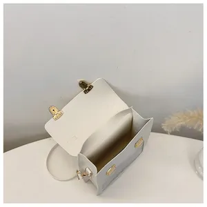 Top-down detail showing white PU leather shoulder bag interior with golden metal buckle