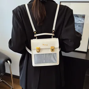 White minimalist square backpack with gold buckles and clear mesh pocket detail