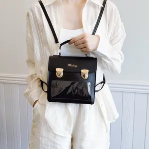 Transparent ita bag in black leather with dual gold locks and PVC window display