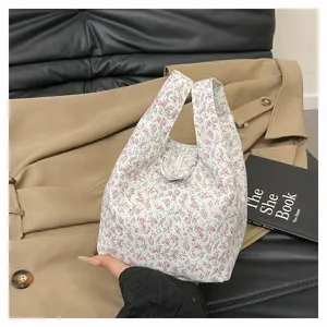 Close-up of floral canvas tote bag with lace bow detail and soft handle grip