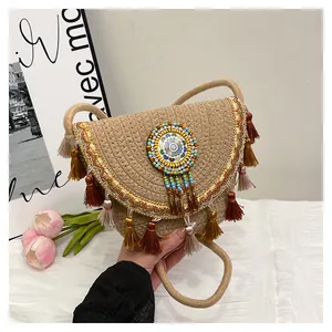 Détail du sac bandoulière bohème avec broderies, pompons et mandala perlé coloré