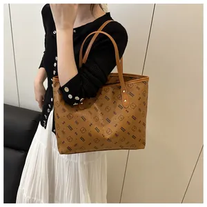 Close-up of the vintage brown tote bag with bear pattern worn on a shoulder