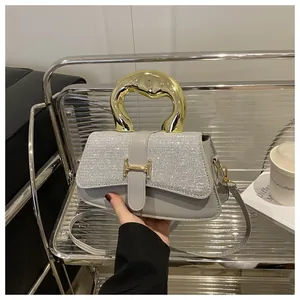 Detail of grey leather handbag with rhinestone flap and gold H-buckle in modern setting