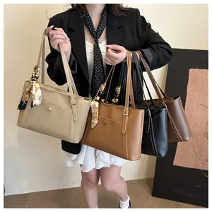 Detail of four large tote bags in beige, camel, black and coffee with silk scarf handle décor