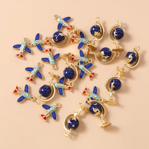 Detail showing red and blue airplane and globe enamel charms for DIY jewelry making